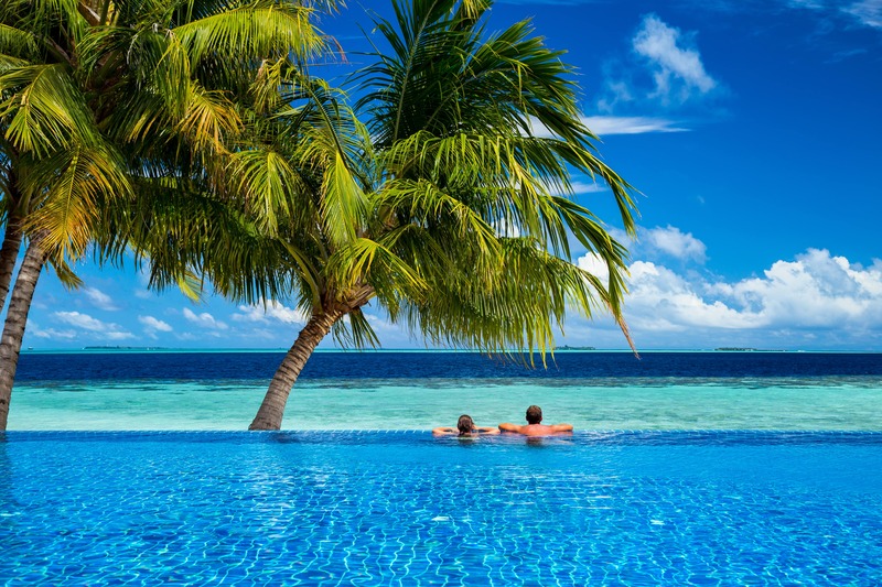 couple in luxury island resort beach pool